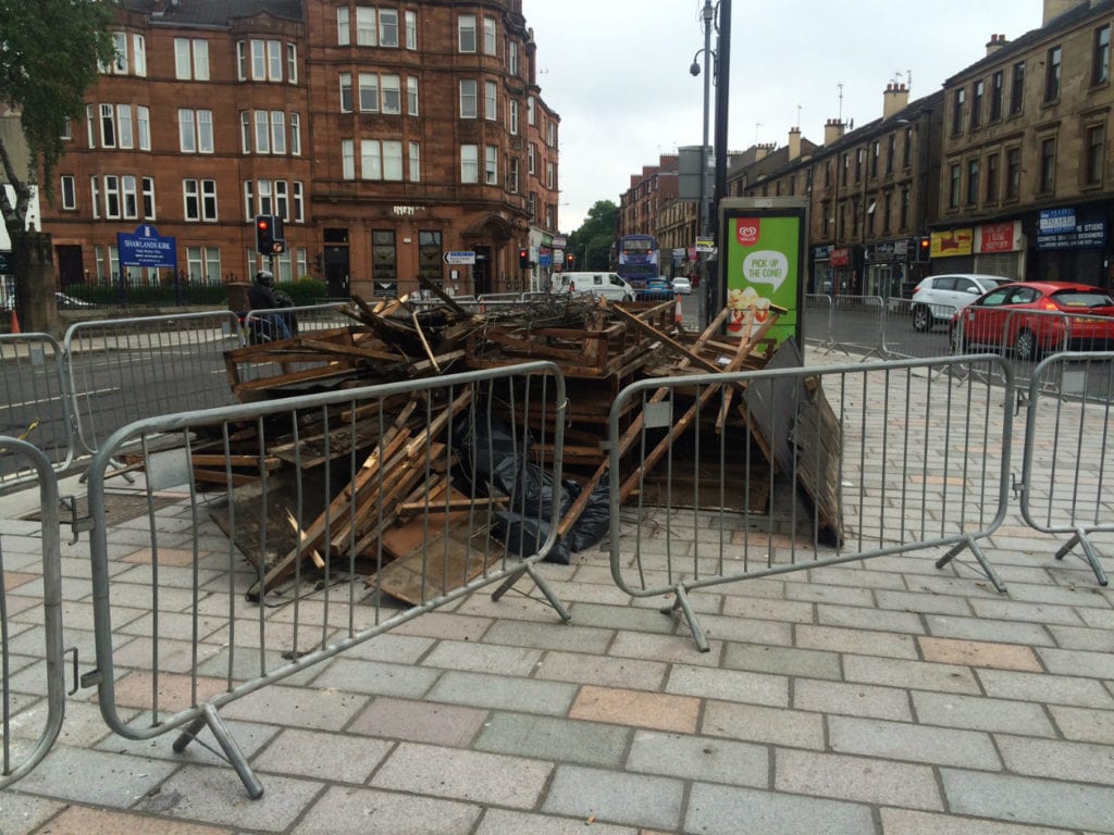 The collapsed signage lies in a heap in a cordoned off area in the street outside the pub. Picture: SM