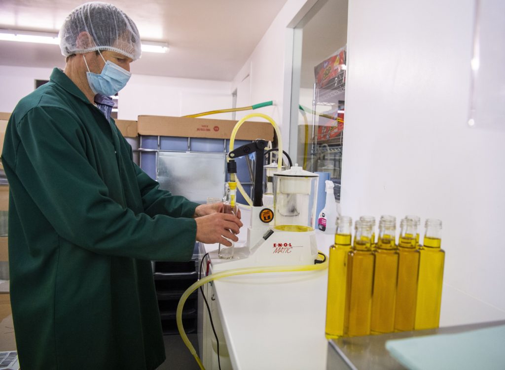 Chris Mann in the bottling plant at Supernature oil. 